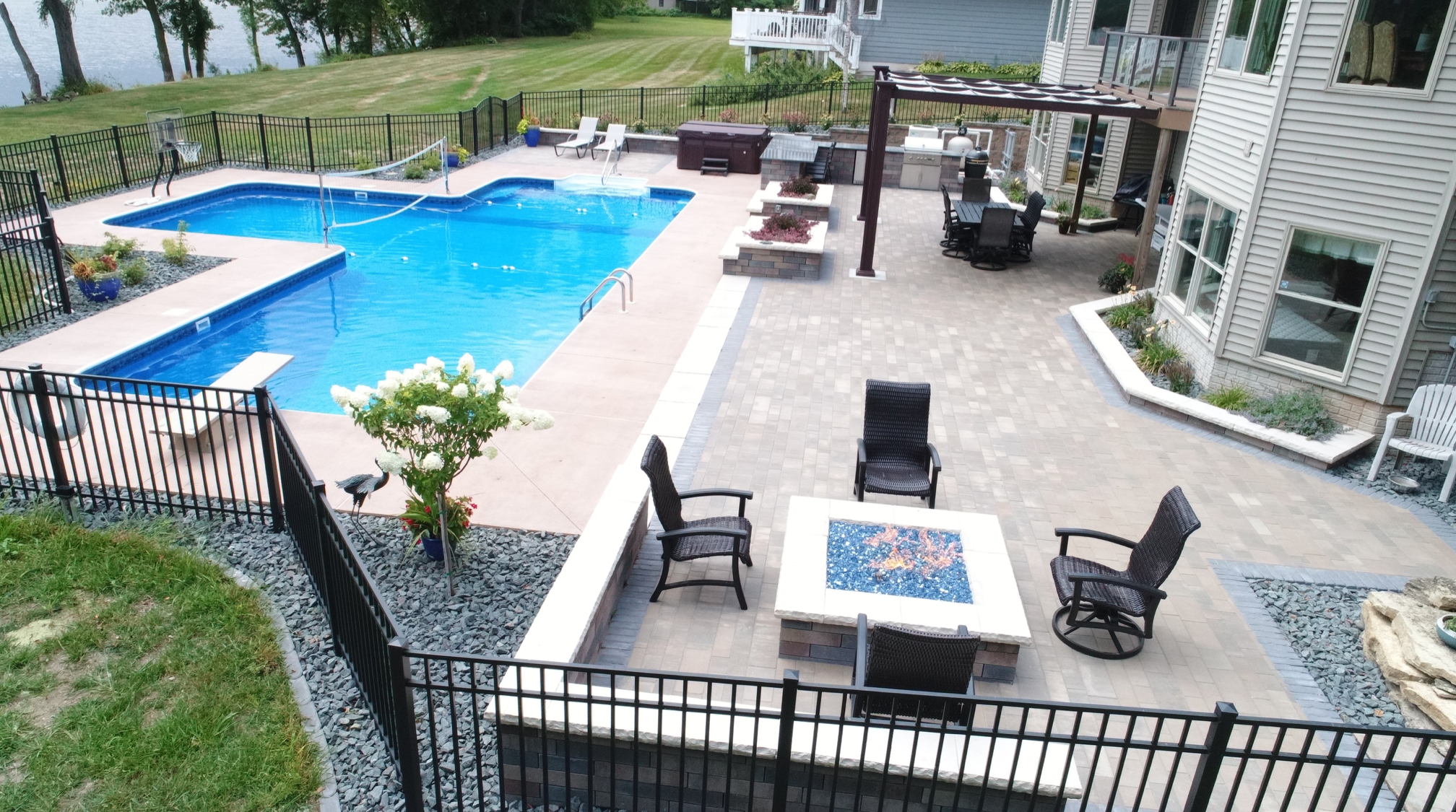 pool with patio and landscaping